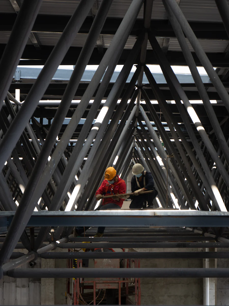 Pedestrians crossing a steel footbridge.