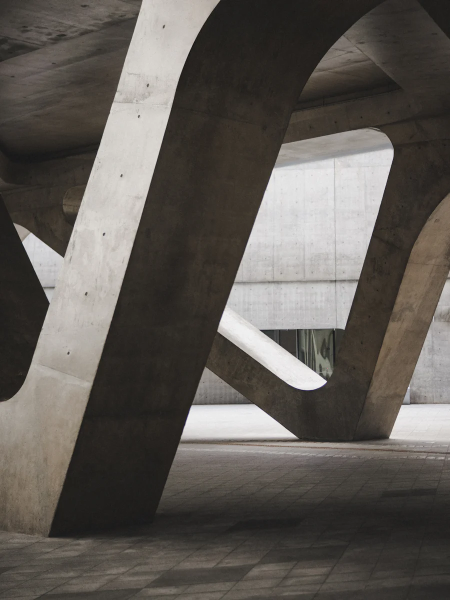 Concrete civic building with a deep cantilevered upper floor.