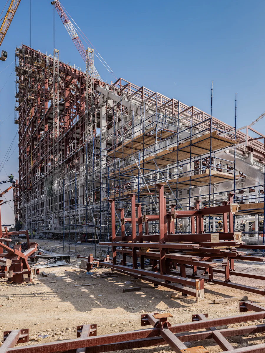 A tall residential tower under construction ringed by cranes.
