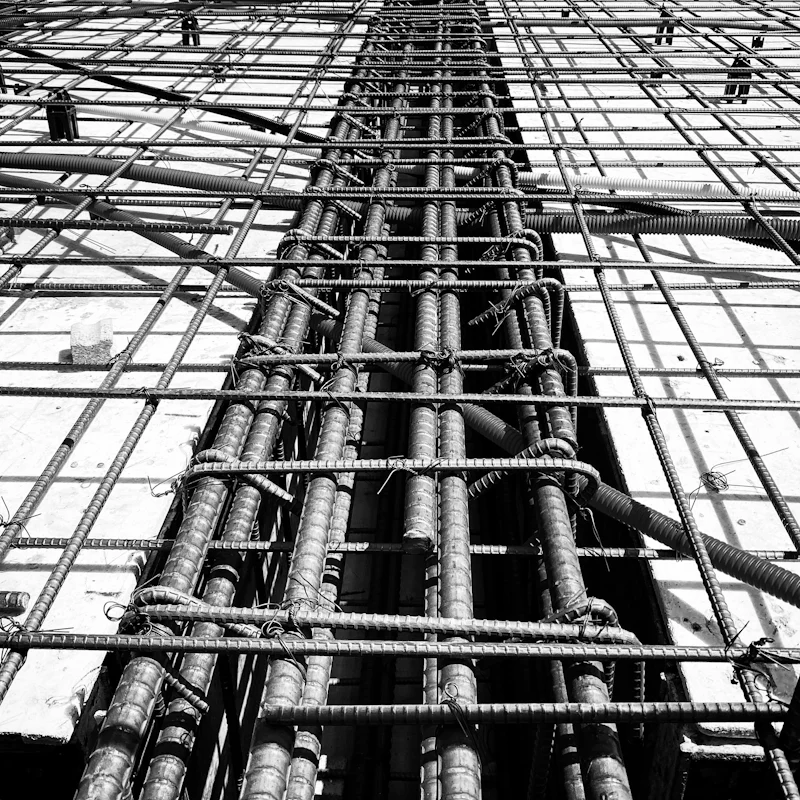 Grid of steel reinforcing bars tied into a dense orthogonal mesh.